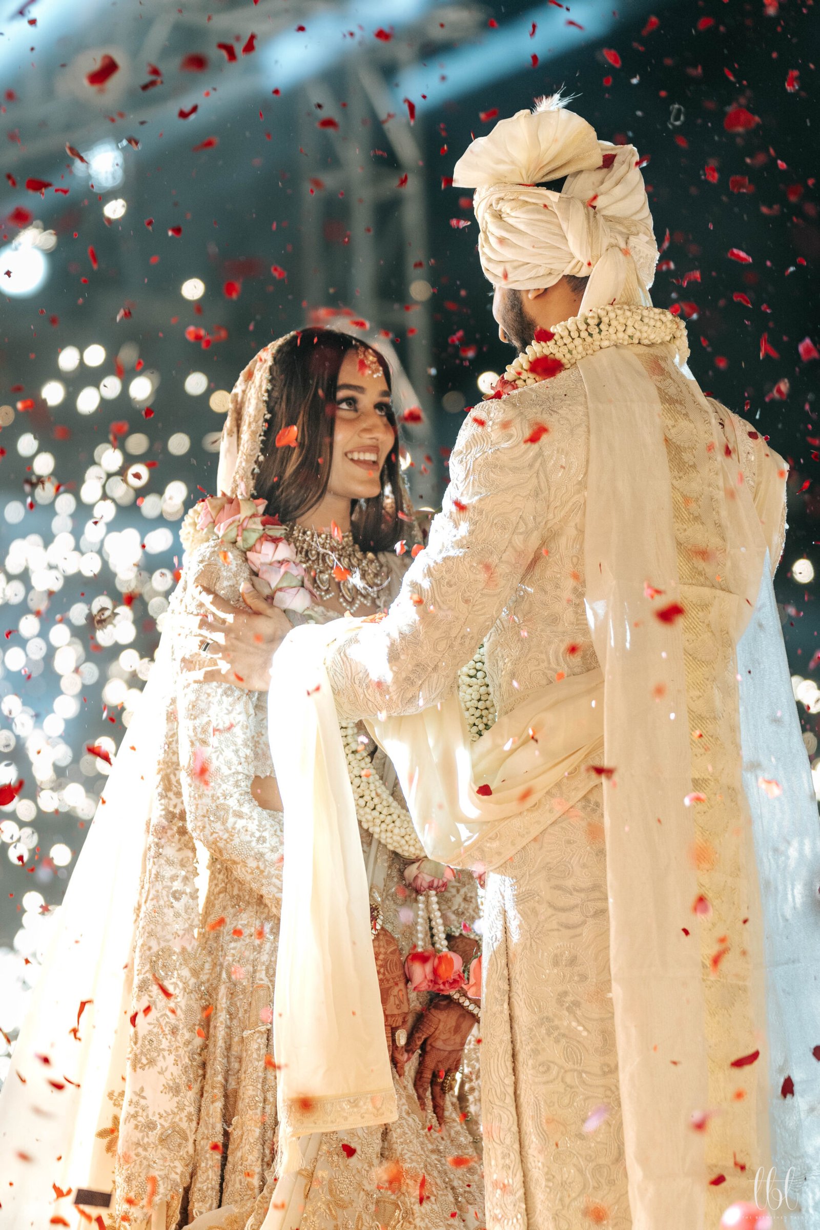 Wedding couple celebrating with flower petals